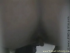 A dark under-toilet camera view of a girl in a skirt sitting on the bowl, pushing out a long, slow one. Dim lighting. Almost 4 minutes.